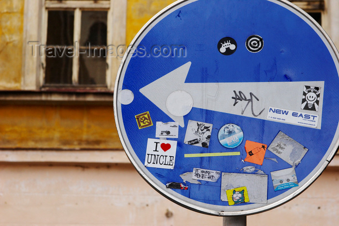 czech409: one way sign full of decals and graffiti. Prague. Czech Republic - photo by H.Olarte - (c) Travel-Images.com - Stock Photography agency - Image Bank