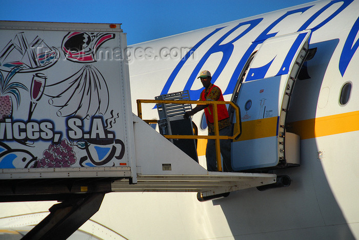 dominican220: Punta Cana, Dominican Republic: Iberworld Airbus A330-322 EC-IJH - catering worker removes trolleys - Punta Cana International Airport - PUJ / MDPC - photo by M.Torres - (c) Travel-Images.com - Stock Photography agency - Image Bank