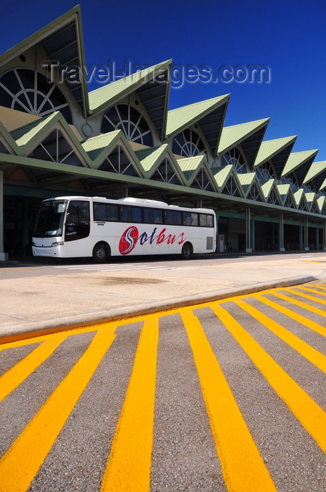 dominican262: El Catey, Samaná province, Dominican republic: landside view of Samaná El Catey International Airport / Presidente Juan Bosch - AZS - pointed roofs, tour bus and yellow lines - photo by M.Torres - (c) Travel-Images.com - Stock Photography agency - Image Bank