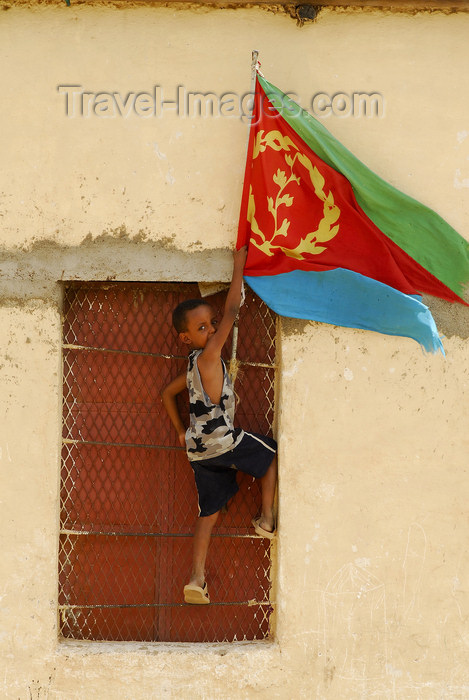 eritrea60: Eritrea - Hagaz, Anseba region - boy placing the flag of Eritrea on a house - photo by E.Petitalot - (c) Travel-Images.com - Stock Photography agency - Image Bank