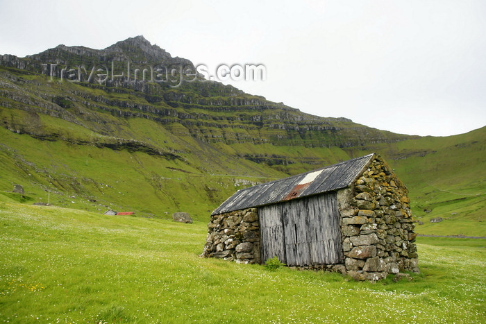 faeroe164: Trøllanes, Kalsoy island, Norðoyar, Faroes: rural cottage under a towering basalt peak - photo by A.Ferrari - (c) Travel-Images.com - Stock Photography agency - Image Bank