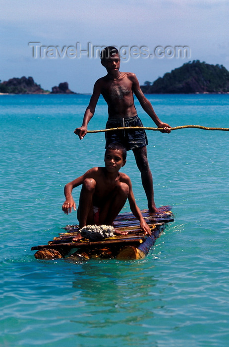 fiji20: Nacula Island, Yasawa group, Fiji: pair boys on an improvised log raft near Mala Kati Village - photo by C.Lovell - (c) Travel-Images.com - Stock Photography agency - Image Bank