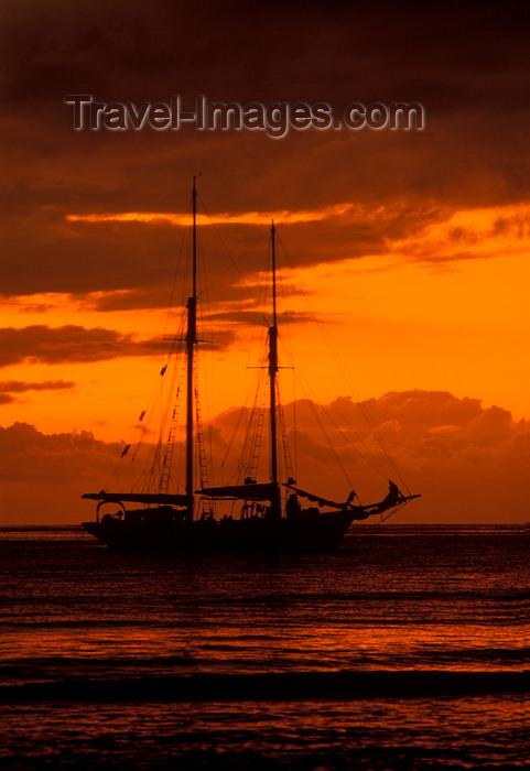 fiji35: Yasawa Islands, Fiji: orange sunset with cloud cover over the Pacific Ocean – silhouette of La Violante, a 1920s double-masted schooner - photo by C.Lovell - (c) Travel-Images.com - Stock Photography agency - Image Bank