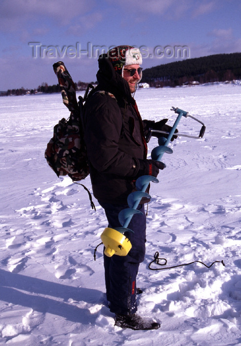 fin113: Finland - Lapland - Rovaniemi - fisherman prepares to drill the ice - Arctic images by F.Rigaud - (c) Travel-Images.com - Stock Photography agency - Image Bank