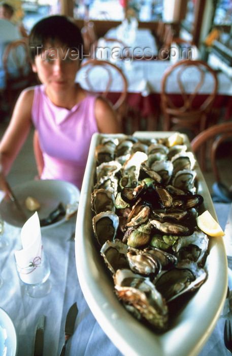 france1026: Sète, Hérault, Languedoc-Roussillon, France: a generous serving of oysters - young lady in a restaurant - photo by K.Gapys - (c) Travel-Images.com - Stock Photography agency - Image Bank