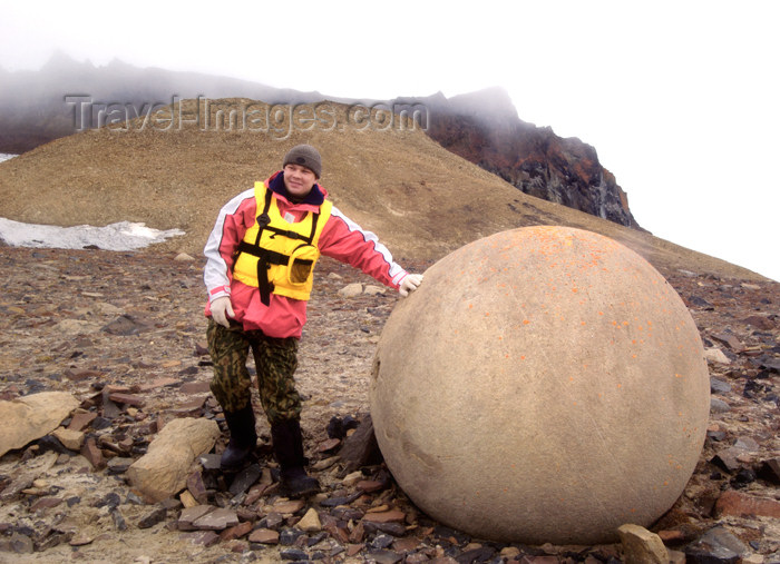 franz-josef51: Franz Josef Land Passenger next to spherical boulder , Champ Island - Arkhangelsk Oblast, Northwestern Federal District, Russia - photo by Bill Cain - (c) Travel-Images.com - Stock Photography agency - Image Bank