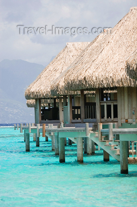 french-polynesia50: Papetoai, Moorea, French Polynesia: InterContinental Hotel - line of overwater bungalows backed by mountains on the north coast - tropical resort view - photo by D.Smith - (c) Travel-Images.com - Stock Photography agency - Image Bank