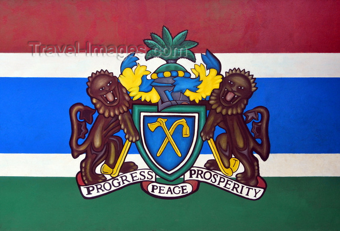 gambia16: Banjul, Gambia: Coat of Arms of the Gambia - Independence drive - two lions holding an axe and hoe, supporting a shield with hoe and axe, crossed, atop the shield is the heraldic helmet and an oil palm as a crest, at the bottom is the national motto: Progress, Peace, Prosperity - photo by M.Torres - (c) Travel-Images.com - Stock Photography agency - Image Bank