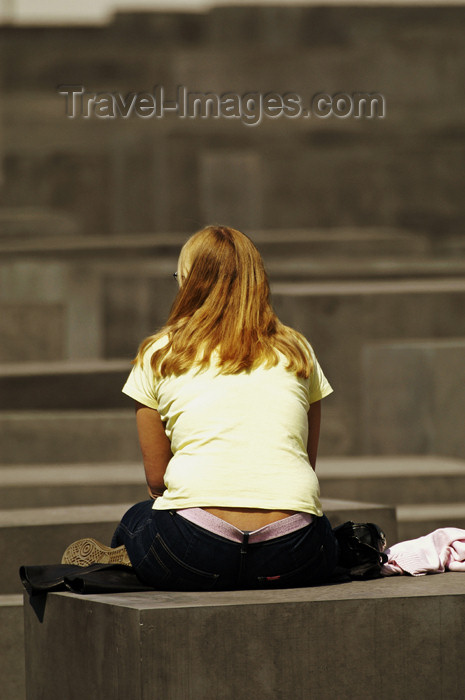 germany276: Germany - Berlin: Holocaust Memorial - girl siting / Holocaust-Mahnmal in Berlin-Mitte wurde am 10. Mai 2005 in Berlin eröffnet und ist seit dem 12. Mai für die Öffentlichkeit zugänlich. Es wurde zum Gedenken an die 6 Millionen von den Nazis ermordeten Juden errichtet - photo by W.Schmidt - Holocaust-Mahnmal in Berlin-Mitte wurde am 10. Mai 2005 in Berlin eröffnet und ist seit dem 12. Mai für die Öffentlichkeit zugänlich. Es wurde zum Gedenken an die 6 Millionen von den Nazis ermordeten Juden errichtet und liegt nahe dem Reichstag und dem Brandenburger Tor.
The Holocaust-Memorial in midtown of Berlin was created by the Architect Peter Eisenman and remembers to the 6 Million Jews murdered by the Nazis. In the picture a young woman visitor has a break sitting on one of the roundabout 2500 columns that form the memorial. - (c) Travel-Images.com - Stock Photography agency - Image Bank