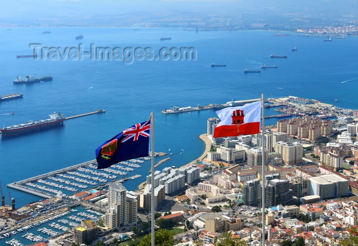 gibraltar59: Gibraltar: flag of Gibraltar (right) and the Government Ensign (left) - seen against the bay of Algeciras and the town - photo by M.Torres - (c) Travel-Images.com - Stock Photography agency - Image Bank