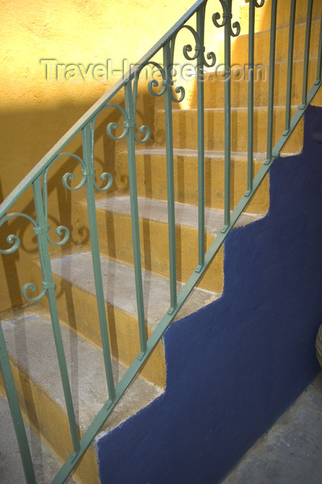 greece353: Greece, Dodecanese Islands, Rhodes: green painted stair guard against blue and orange painted steps - (c) Travel-Images.com - Stock Photography agency - Image Bank