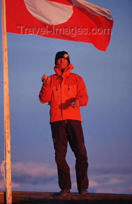 greenland79: Greenland, Apussuit: skier juggling in front of the Greenland flag - photo by S.Egeberg - (c) Travel-Images.com - Stock Photography agency - Image Bank