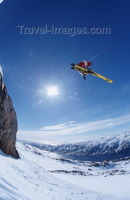 greenland80: Greenland, Apussuit: skier taking air off high ice cliff - sun - photo by S.Egeberg - (c) Travel-Images.com - Stock Photography agency - Image Bank