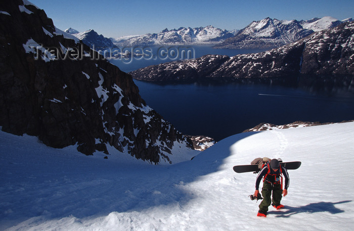 greenland87: Greenland, Apussuit: snowboarder with heavy load climbing steep snow slope - photo by S.Egeberg - (c) Travel-Images.com - Stock Photography agency - Image Bank