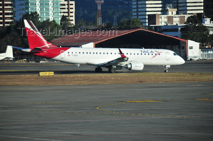 guatemala28: Ciudad de Guatemala / Guatemala city: airport - La Aurora International Airport - TACA - Embraer 190-100IGW (TI-BCH) - aircraft taxiing - IATA: GUA - photo by M.Torres - (c) Travel-Images.com - Stock Photography agency - Image Bank