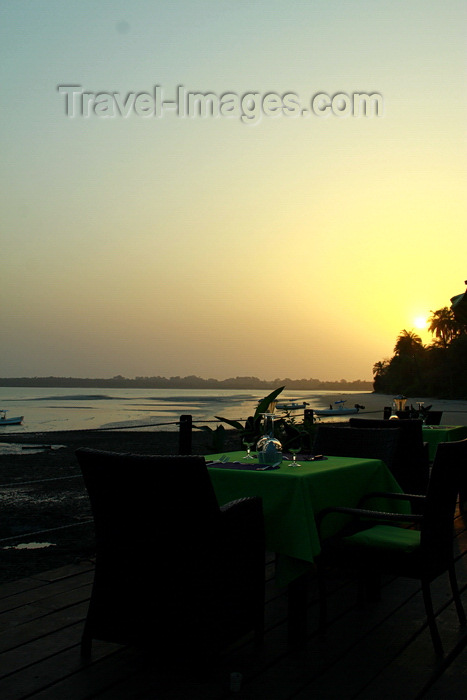 guinea-bissau113: Rubane Island, Bijagós Archipelago - UNESCO biosphere reserve, Bubaque sector, Bolama region, Guinea Bissau / Guiné Bissau: Sunset, view of beach, palm trees, beachfront restaurant at Hotel Punta Anchaca / pôr-do-sol, paisagem da praia, palmeiras, esplanada do Hotel Punta Anchaca- photo by R.V.Lopes - (c) Travel-Images.com - Stock Photography agency - Image Bank