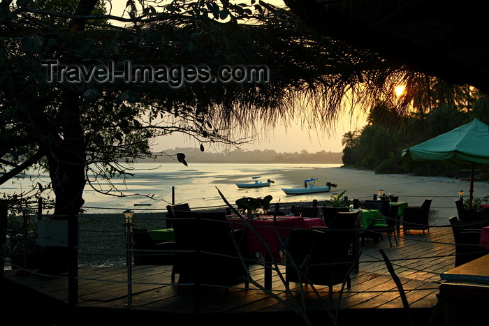 guinea-bissau114: Rubane Island, Bijagós Archipelago - UNESCO biosphere reserve, Bubaque sector, Bolama region, Guinea Bissau / Guiné Bissau: Sunset, view of beach, palms, boats, beachfront restaurant at Hotel Punta Anchaca/ pôr-do-sol, paisagem da praia, palmeiras, barcos, esplanada do Hotel Punta Anchaca- photo by R.V.Lopes - (c) Travel-Images.com - Stock Photography agency - Image Bank