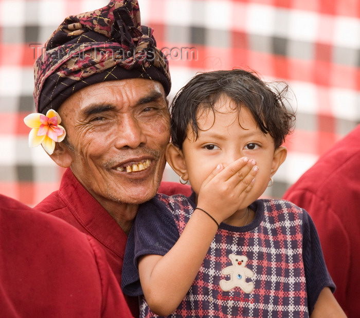 indonesia124: Padangbai, Bali, Indonesia: toddler and musician with frangipani and turban - photo by D.Smith - (c) Travel-Images.com - Stock Photography agency - Image Bank