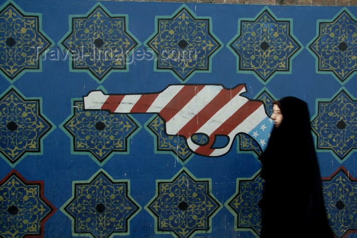 iran570: Tehran, Iran: propaganda - Graffiti at the former US embassy - psychedelic gun and woman in chador - photo by G.Koelman - (c) Travel-Images.com - Stock Photography agency - Image Bank