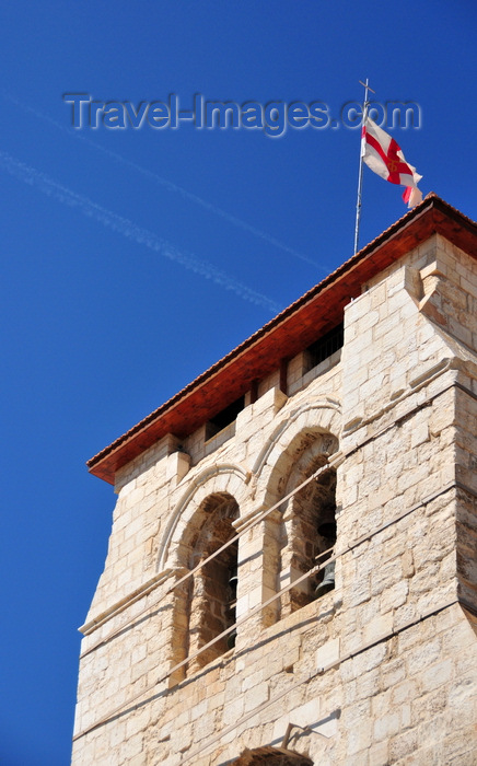 israel437: Jerusalem, Israel: Holy Sepulcher church - bell tower, contrails and flag of the Brotherhood of the Holy Sepulchre - Greek T and F, for 'taphos' meaning sepulcher - Christian quarter - photo by M.Torres - (c) Travel-Images.com - Stock Photography agency - Image Bank