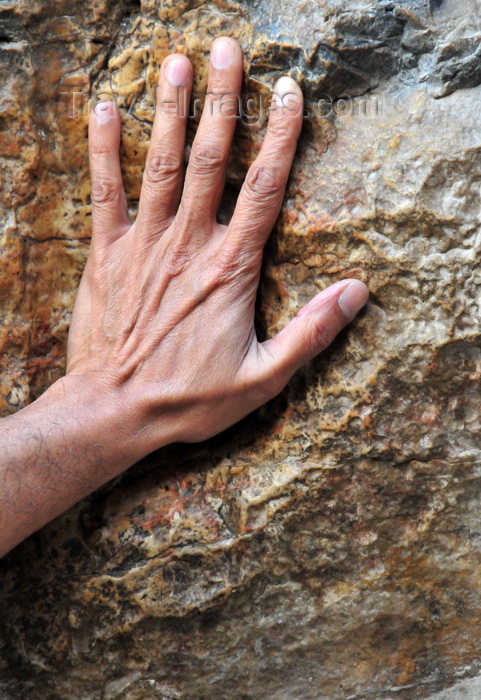 israel456: Jerusalem, Israel: Via Dolorosa - hand over the cavity which is said to be the imprint of Jesus hand, near 5th station - photo by M.Torres - (c) Travel-Images.com - Stock Photography agency - Image Bank