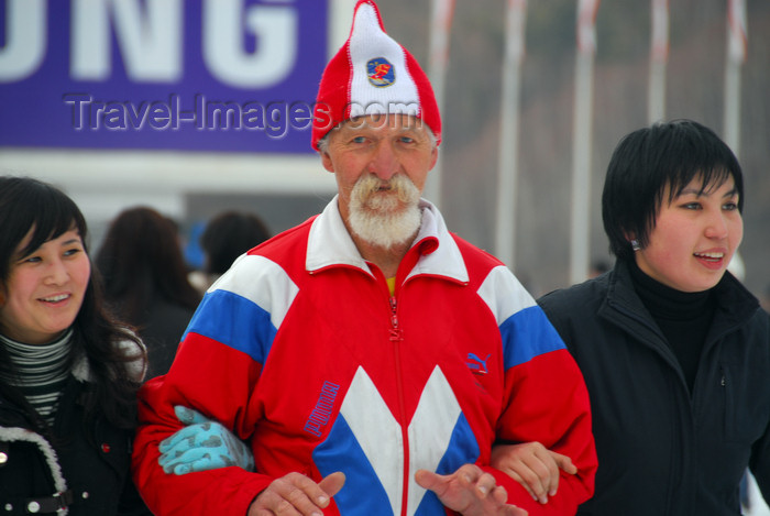 kazakhstan172: Kazakhstan,Medeu ice stadium, Almaty: old Russian man leading two Kazakh girls - photo by M.Torres - (c) Travel-Images.com - Stock Photography agency - Image Bank