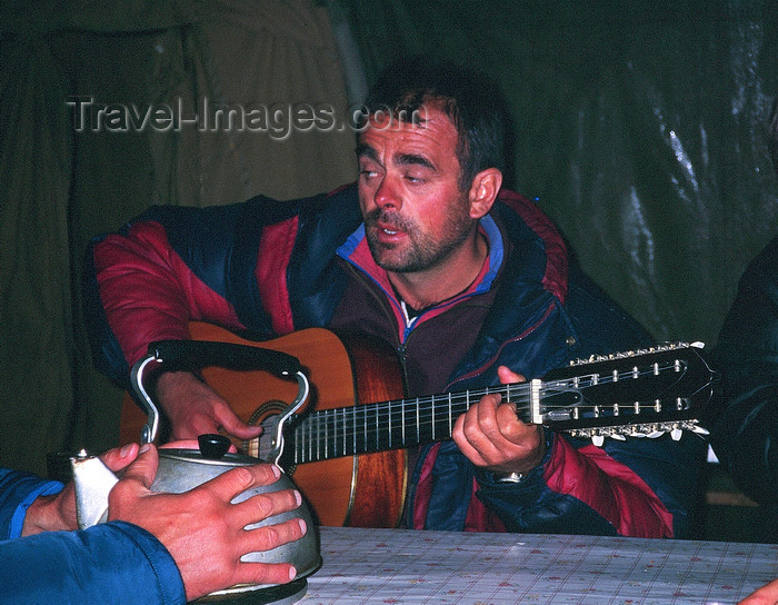 kazakhstan41: Kazakhstan - Almaty oblys: a guitarist plays and a man warms his hand on a kettle - photo by E.Petitalot - (c) Travel-Images.com - Stock Photography agency - Image Bank