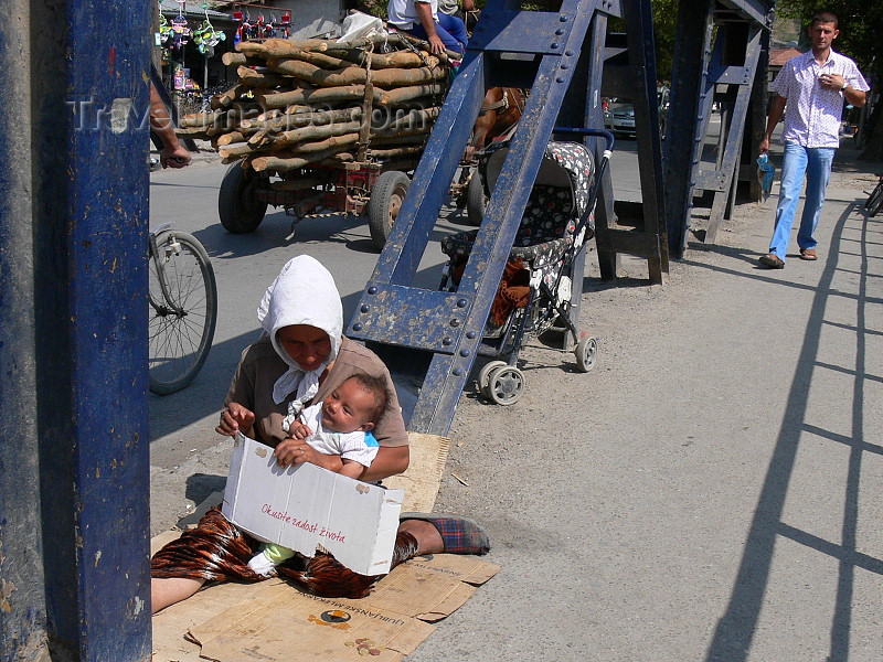 kosovo51: Kosovo - Pec / Peja: 'Try the joys of life' - beggar with sign and baby - photo by J.Kaman - (c) Travel-Images.com - Stock Photography agency - Image Bank