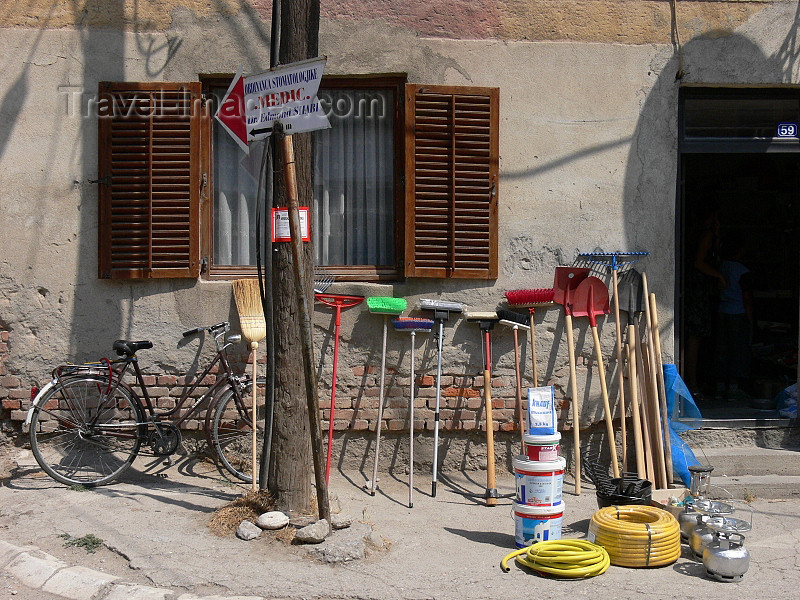 kosovo52: Kosovo - Pec / Peja: broom and hardware store - tools and 'medic' sign - photo by J.Kaman - (c) Travel-Images.com - Stock Photography agency - Image Bank