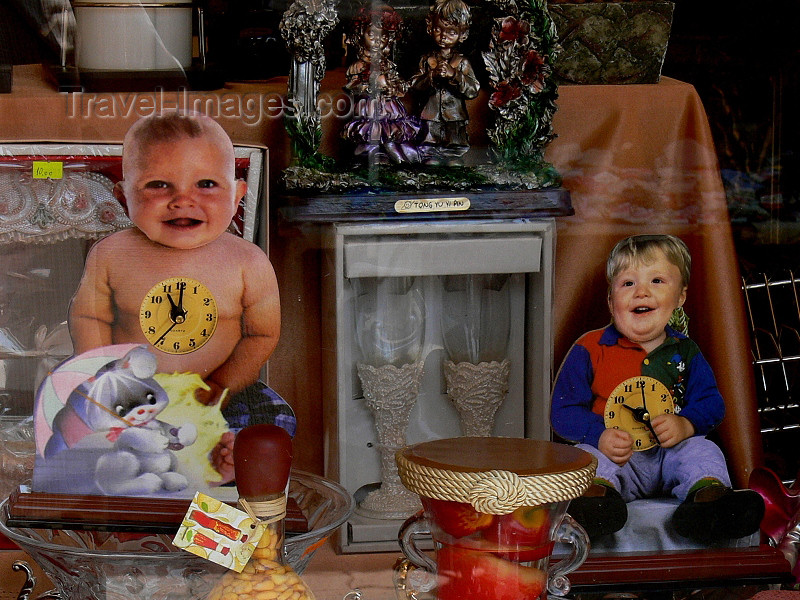 kosovo53: Kosovo - Pec / Peja: baby clock in shop window - Chinese imports - photo by J.Kaman - (c) Travel-Images.com - Stock Photography agency - Image Bank