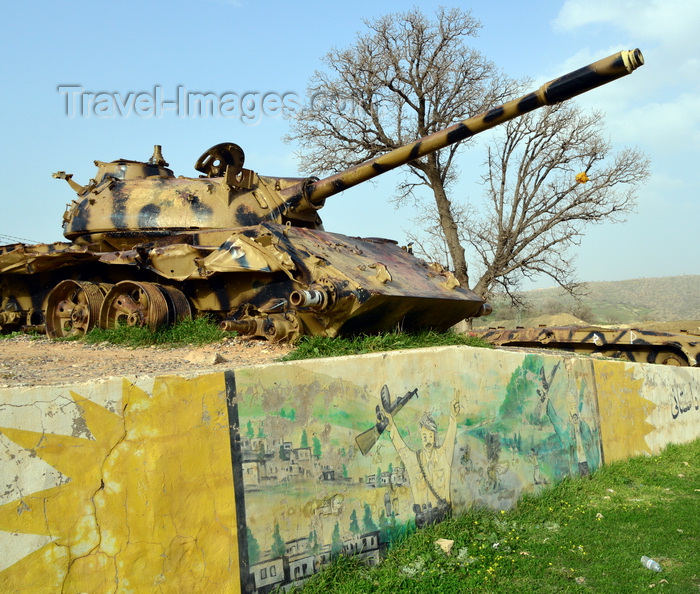 kurdistan99: Shera Swars, Kurdistan, Iraq: wrecked Iraqi army T-55 tanks, destroyed in combat by the Kurdish Peshmerga forces in a battle in 1991 - mural celebrating the Kurdish victory - photo by M.Torres - (c) Travel-Images.com - Stock Photography agency - Image Bank