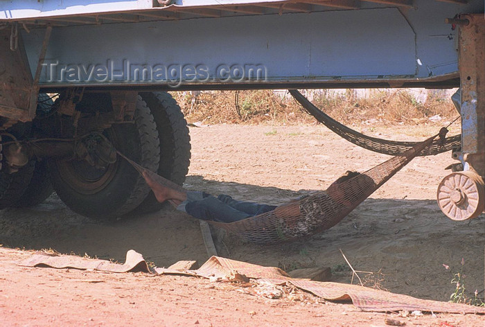 laos109: Laos: a driver takes time off in a hammock in the shade under his truck - photo by E.Petitalot - (c) Travel-Images.com - Stock Photography agency - Image Bank