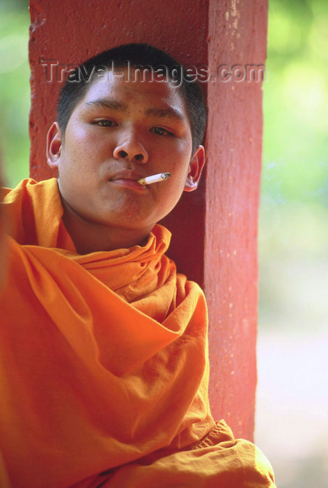 laos99: Laos: a yong monk smokes a cigarette - photo by E.Petitalot - (c) Travel-Images.com - Stock Photography agency - Image Bank