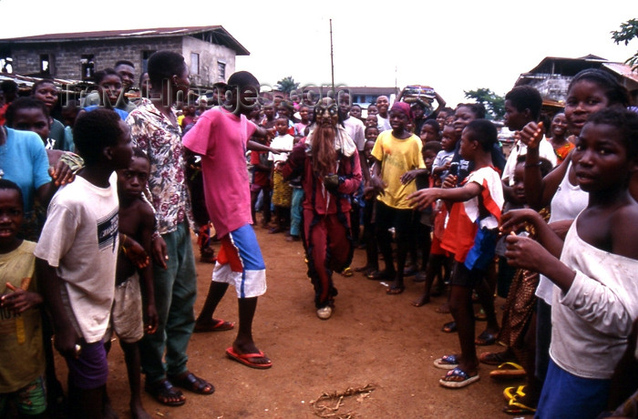 liberia33: Grand Bassa County, Liberia, West Africa: masked man and crowd - photo by M.Sturges - (c) Travel-Images.com - Stock Photography agency - Image Bank