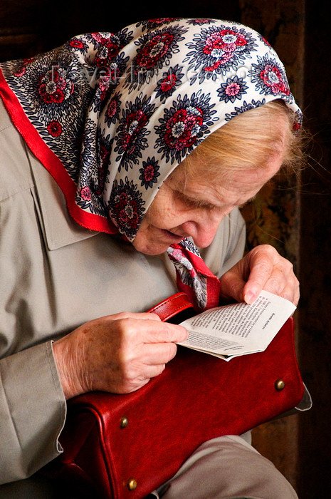 lithuania197: Vilnius, Lithuania: elderly woman reading the Bible in Chapel of the Blessed Mary - photo by J.Pemberton - (c) Travel-Images.com - Stock Photography agency - Image Bank