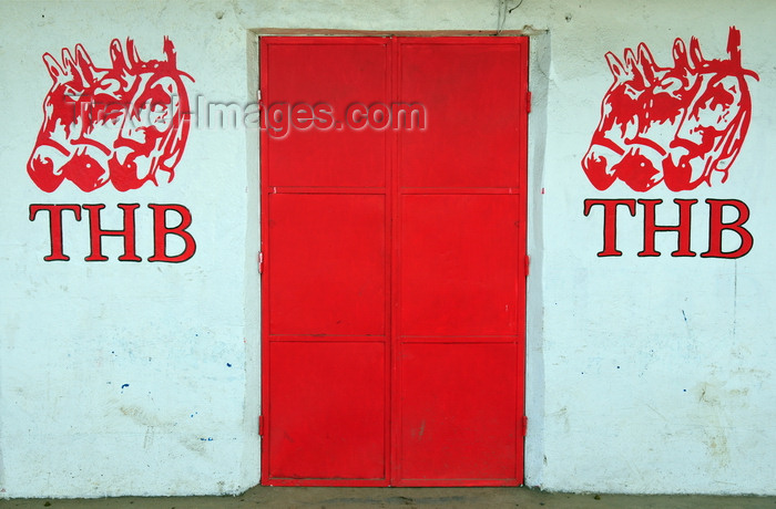 madagascar141: Moramanga, Alaotra-Mangoro, Toamasina Province, Madagascar: white wall, red gate and THB ads, Tree Horses Beer - photo by M.Torres - (c) Travel-Images.com - Stock Photography agency - Image Bank