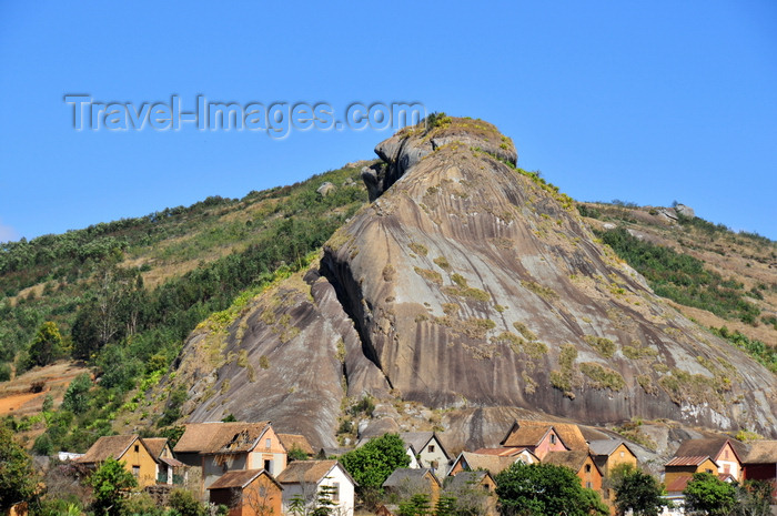 madagascar160: RN2, Alaotra-Mangoro region, Toamasina Province, Madagascar: village under a giant rock pyramid - photo by M.Torres - (c) Travel-Images.com - Stock Photography agency - Image Bank