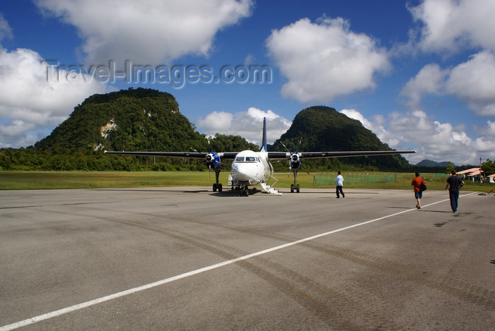 mal523: Mulu Airport, Sarawak, Borneo, Malaysia: MASwings Fokker F50 twin turboprop on the tarmac at MZV, gateway to Gunung Mulu National Park - 9M-MGB cn 20156 - karstic hills covered in vegetation in the background - photo by A.Ferrari - (c) Travel-Images.com - Stock Photography agency - Image Bank