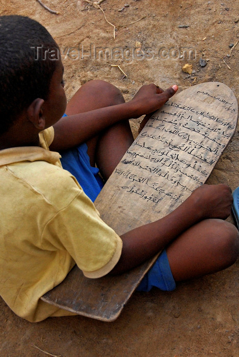 mali61: Djenné, Mopti Region, Mali: boy studying Quranic verses on a wooden tablet at the Madrassa - photo by J.Pemberton - (c) Travel-Images.com - Stock Photography agency - Image Bank