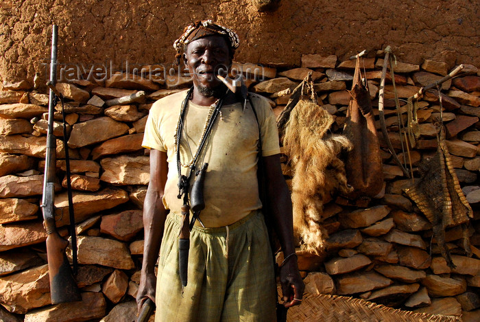 mali65: Bandiagara Escarpment, Dogon country, Mopti region, Mali: hunter with his weapon, pipe and trophies - photo by J.Pemberton - (c) Travel-Images.com - Stock Photography agency - Image Bank