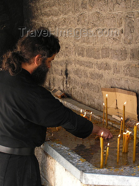 montenegro51: Montenegro - Crna Gora - Cetinje - old capital of Montenegro: inside the Bogorodicin Orthodox Monastery / Bogorodicin monastyr - monk and candles - photo by J.Kaman - (c) Travel-Images.com - Stock Photography agency - Image Bank