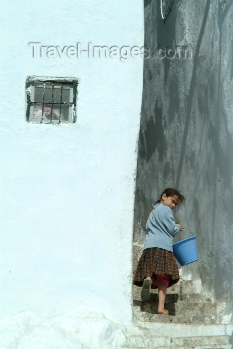 moroc321: Morocco / Maroc - Chechaouen: getting water - Berber girl with bucket - stairs - Medina - Rif - photo by J.Banks - (c) Travel-Images.com - Stock Photography agency - Image Bank