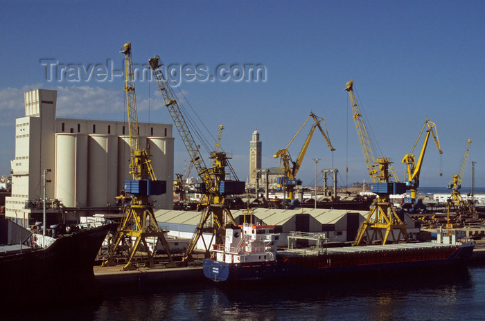 moroc556: Casablanca, Morocco: ships and cranes in the port - grain elevator and Hassan II mosque in the background - photo by S.Dona' - (c) Travel-Images.com - Stock Photography agency - Image Bank
