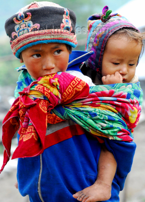 nepal113: Nepal - Langtang region - old sister carring her young brother - photo by E.Petitalot - (c) Travel-Images.com - Stock Photography agency - Image Bank