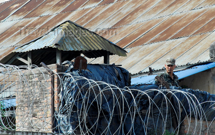 nepal127: Kathmandu, Nepal: a soldier behind razor wire in a Nepalese army supervision post - concertina wire - photo by E.Petitalot - (c) Travel-Images.com - Stock Photography agency - Image Bank