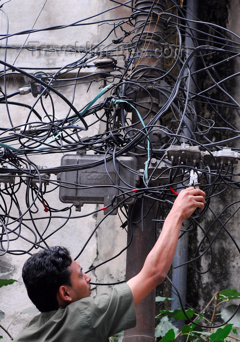 nepal130: Kathmandu, Nepal: an electrician working in Katmandou street - chaotic wires - photo by E.Petitalot - (c) Travel-Images.com - Stock Photography agency - Image Bank