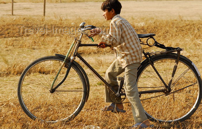 nepal132: Kathmandu, Nepal: child riding an adult bicycle - photo by E.Petitalot - (c) Travel-Images.com - Stock Photography agency - Image Bank