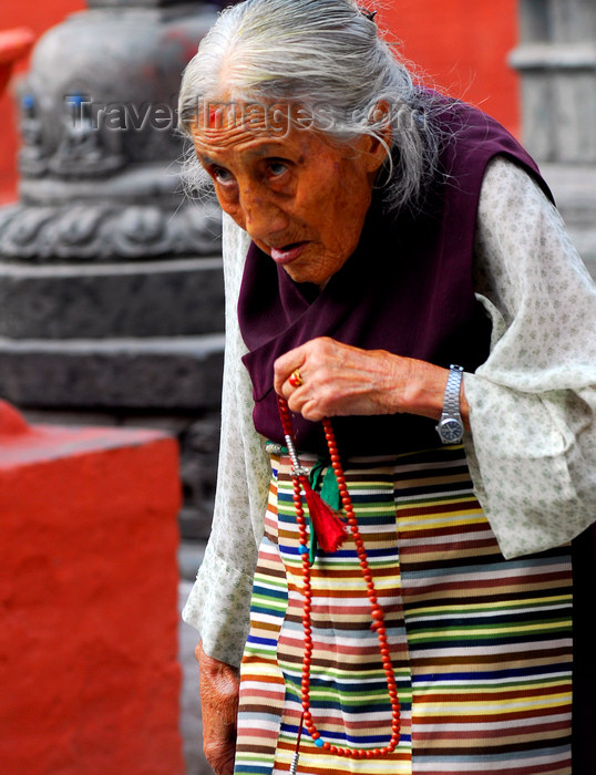 nepal141: Kathmandu, Nepal: an old Tibetan woman recites prayers around a Buddhist temple - photo by E.Petitalot - (c) Travel-Images.com - Stock Photography agency - Image Bank