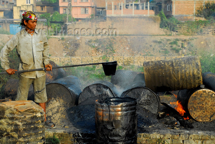 nepal144: Kathmandu, Nepal: man preparing asphalt - difficult work conditions - photo by E.Petitalot - (c) Travel-Images.com - Stock Photography agency - Image Bank