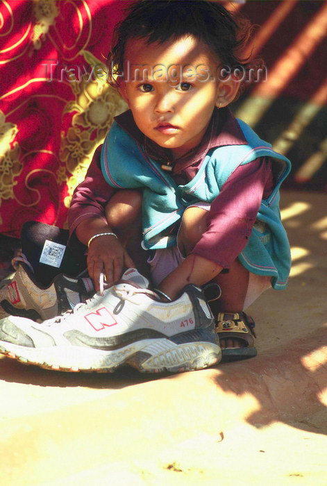 nepal161: Pokhara, Nepal: toddler playing with adult shoe - photo by E.Petitalot - (c) Travel-Images.com - Stock Photography agency - Image Bank